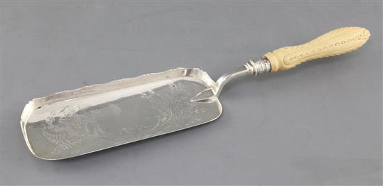 A Victorian silver crumb scoop with carved ivory handle, 35.6cm.